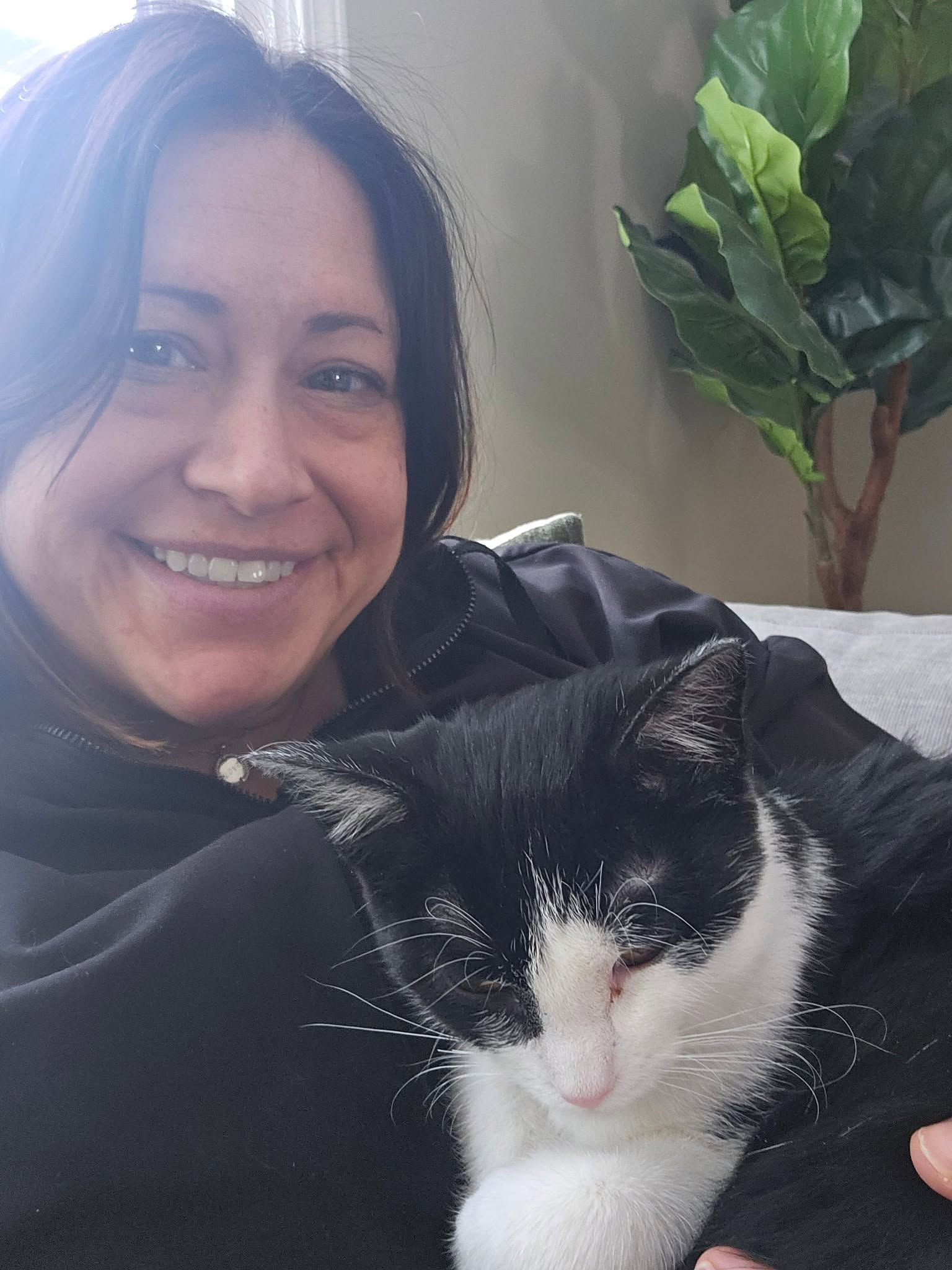 Julie holding a tuxedo cat
